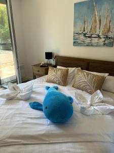 a blue stuffed animal sitting on top of a bed at Elina Apartman in Keszthely