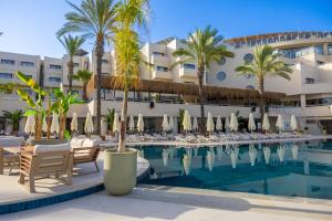 a pool at a hotel with chairs and umbrellas at Arin Resort Bodrum in Turgutreis
