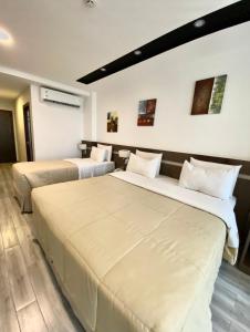 Ліжко або ліжка в номері Hotel Sun