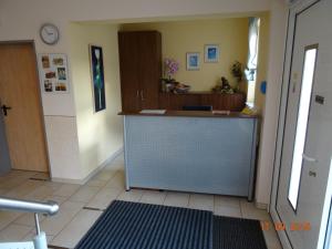 a room with a hallway with a counter and a door at Pension Alram Hof in Eggenfelden