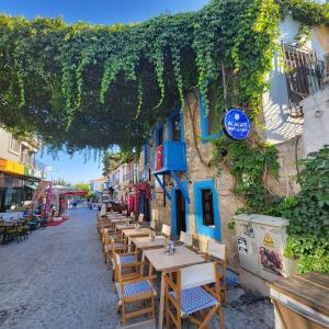 a row of tables and chairs outside of a building at Kapela Taş Otel Alaçatı in Çeşme