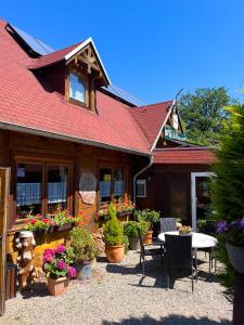 a building with potted plants and a table in front of it at Haus Ehrenbreitstein in Lahnstein
