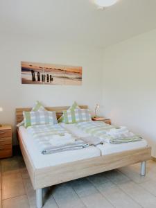 a bed in a bedroom with a painting on the wall at Haus Ehrenbreitstein in Lahnstein