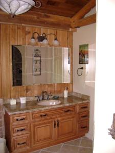 a bathroom with a sink and a mirror at Lake Escape To An Elegant 4 Br Home in Huddleston +55 photos