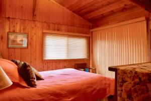 a bedroom with a bed in a wooden room at Lake Escape To An Elegant 4 Br Home in Huddleston