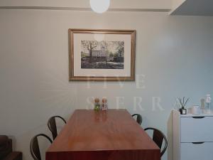 a dining room table with chairs and a picture on the wall at At Five Sierra - 1BR Condo in One Regis Megaworld in Bacolod