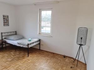 a room with a bed and a window at Promotion Prices Monteurwohnung nahe Pforzheim und Karlsruhe in Birkenfeld +6 photos