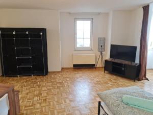 a living room with a flat screen tv and a living room at Promotion Prices Monteurwohnung nahe Pforzheim und Karlsruhe in Birkenfeld