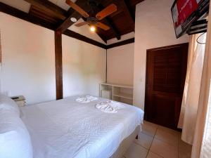 Cama ou camas em um quarto em Pousada Vila do Sol Juquehy