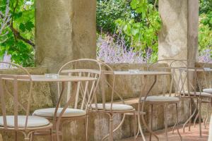 a row of tables and chairs in a patio at Hôtel La Figuière in Saint-Tropez