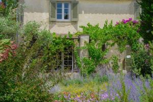 a garden with flowers in front of a building at Hôtel La Figuière in Saint-Tropez