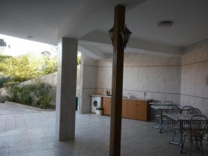 a room with tables and chairs and a kitchen at Uyutny Dom in Vardane