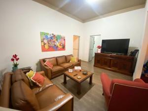 a living room with a couch and a coffee table at Casa Bizzacchi in Espirito Santo Do Pinhal