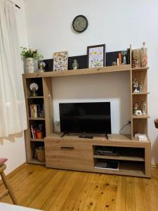 a wooden entertainment center with a flat screen tv at Apartman Plužine in Plužine