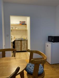 a dining room with a table and chairs and a refrigerator at Apartman Plužine in Plužine
