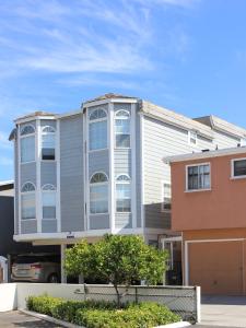 a gray building with white windows on a street at 1404 W Oceanfront A in Newport Beach +2 photos