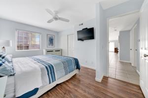 a bedroom with a bed and a flat screen tv at 1404 W Oceanfront A in Newport Beach
