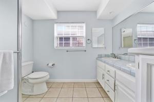 a white bathroom with a toilet and a sink at 1404 W Oceanfront A in Newport Beach
