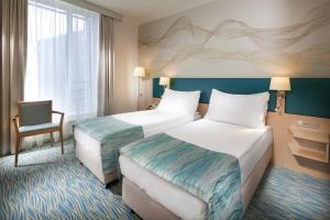 Postel nebo postele na pokoji v ubytování Holiday Inn Prague by IHG + 37 fotografií
