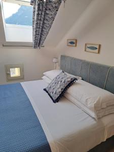 a bedroom with a large bed with a window at Mim&igrave; sul Mare in Massa Lubrense