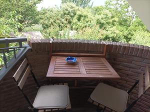 a picnic table and two chairs on a patio at Tenuta Vitale - Azienda agricola multifunzionale in Montoro Inferiore +23 photos