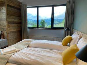 Postel nebo postele na pokoji v ubytování Kaliba Cabins