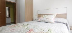 a bedroom with a bed with a pillow on it at Reivi Vilanova de Arousa in Villanueva de Arosa