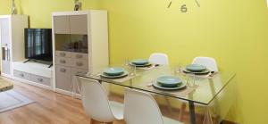 a dining room with a glass table and white chairs at Reivi Vilanova de Arousa in Villanueva de Arosa +25 photos