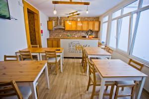 a dining room with wooden tables and chairs at Guest House 10 de Agosto in Figueira da Foz