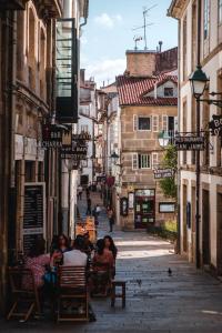 a group of people sitting at tables on a street at Reivi Vilanova de Arousa in Villanueva de Arosa