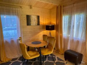 a small table and chairs in a room with a window at Saulkrasti Beach Cottage in Saulkrasti