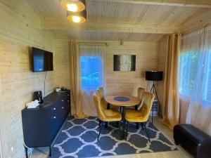 a dining room with a table and chairs in a room at Saulkrasti Beach Cottage in Saulkrasti