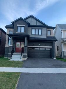 a house with a garage with a red door at Niagara Falls BNB 15 mins away from Falls in Thorold