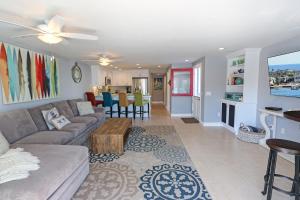 a living room with a couch and a table at 3 Bedrooms in Newport Beach +17 photos
