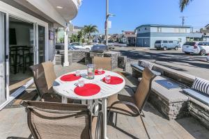a white table and chairs on a balcony with a street at 3 Bedrooms in Newport Beach