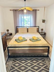 a bedroom with a bed with two towels on it at Evangeo Seaview Apartment Epanomi in Epanomi
