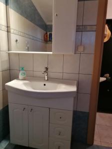 a bathroom with a white sink and a mirror at ESD House in Dhíkella +10 photos