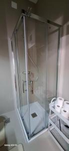 a shower with a glass enclosure in a bathroom at Apartments ROKO in Izola