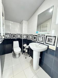 a bathroom with a white toilet and a sink at Tbilisi Center Hotel in Tbilisi City