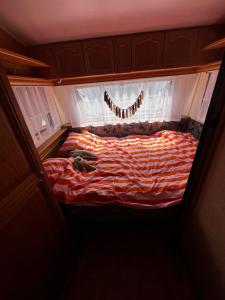 a large bed in a room with a window at Kergulena in Hel
