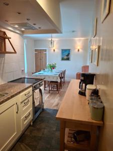 a kitchen with a table and a dining room at Aberlour Cottages - Bolthole & Retreat in Aberlour