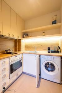 a kitchen with a washing machine and a sink at Magisto Loft in Nea Moudania +46 photos
