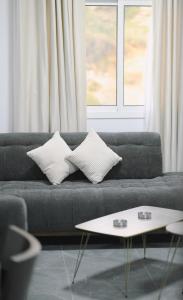 a living room with a couch with pillows and a table at Chouf View Residence in Baddah