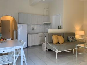 a living room with a couch and a kitchen at Gkely's apartment 1 in Kamena Vourla