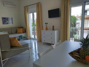 a living room with a couch and a table at Gkely's apartment 1 in Kamena Vourla