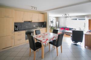 a kitchen and dining room with a table and chairs at Gästehaus Federseeflair in Bad Buchau
