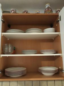a cupboard filled with plates and bowls and dishes at Chalupa Sehradický mlýn in Sehradice