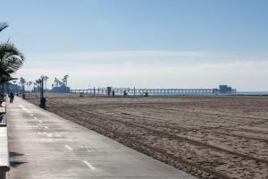 a sandy beach with a pier in the background at 3112 W Oceanfront A in Newport Beach