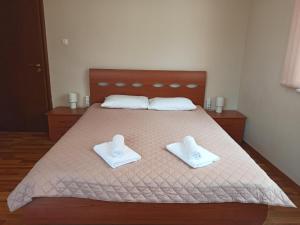 a bedroom with a bed with two white towels on it at Statevi Guest Apartment in Velingrad