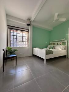 a bedroom with a bed and a table and a window at Marvel Sea View 3 in Akrogiali